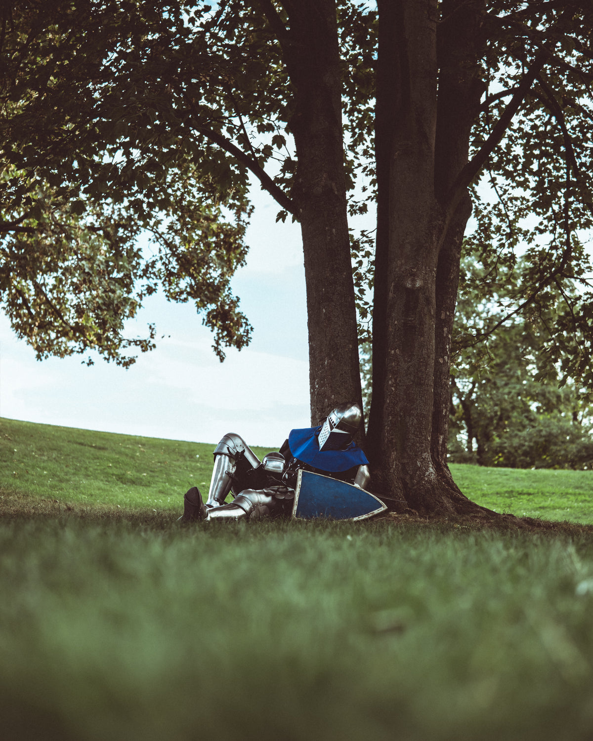Knight resting beneath a tree in PSM armor